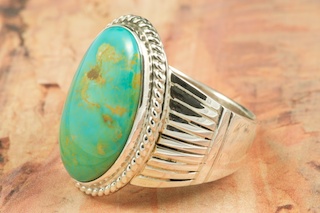 Genuine Manassa Turquoise set in Sterling Silver Ring. This Turquoise is also referred to as King�s Manassa Turquoise. The Manassa Turquoise mine is located in Manassa, Conejos County, Colorado. Created by Navajo Artist Phillip Sanchez. Signed. 